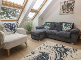 A living room with a sofa and armchair at Upper Deck in Truro