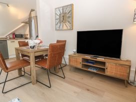A dining room with a table and chairs at Upper Deck in Truro