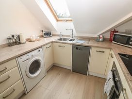 A kitchen with appliances and a sink at Upper Deck in Truro