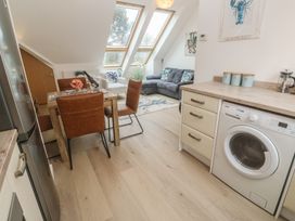 A dining room with a table and chairs and a sofa in Upper Deck in Truro