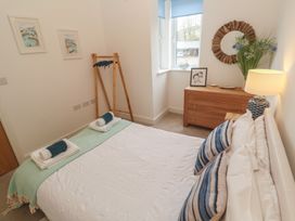 A bedroom with a bed and dresser at Upper Deck in Truro