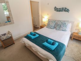 A bedroom with a double bed and side tables at Upper Deck in Truro
