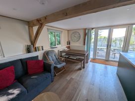 A living room with a sofa and a dining table at Roman Lodge in Osmington