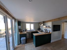 A kitchen with a sink and appliances at Roman Lodge in Osmington