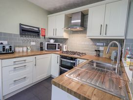 A kitchen with appliances and sink at 8 Beechwood Close Bowness-On-Windermere