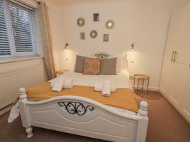 A bedroom with a bed and bedside table at 8 Beechwood Close Bowness-On-Windermere