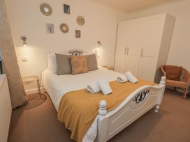 A bedroom with a bed and wardrobe at 8 Beechwood Close Bowness-On-Windermere