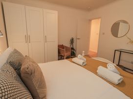 A bedroom with a bed and wardrobe at 8 Beechwood Close Bowness-On-Windermere