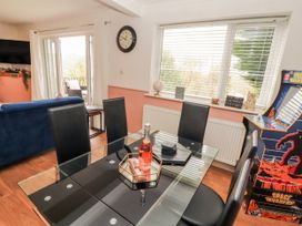 A dining room with a table and chairs at Lake View in Bowness-On-Windermere