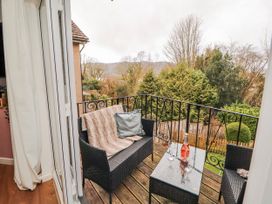 A balcony with seating and a table at Lake View in Bowness-On-Windermere