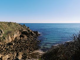 A coastal view of rocks and ocean at Faraway Cottage in St. Levan near Porthgwarra