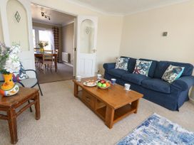 A living room with a sofa and coffee table at Cove Cottage in Weymouth