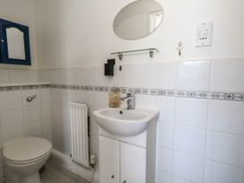 A bathroom with a sink and toilet at Cove Cottage in Weymouth