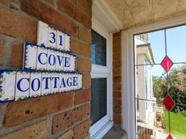 House number and cottage name on a brick wall at Cove Cottage in Weymouth