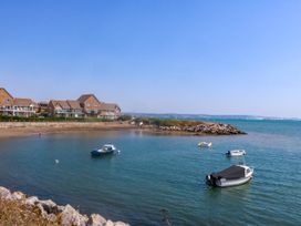 A view of houses and boats on water at Cove Cottage in Weymouth