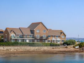 A building with balconies and windows at Cove Cottage in Weymouth