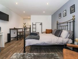 A bedroom with a bed and desk at Chalet 2 East Heslerton near Sherburn