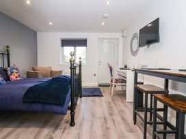 A bedroom with a bed, chair, and television at Chalet 3 in Sherburn