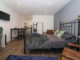 A bedroom with a bed and table at Chalet 4 East Heslerton near Sherburn