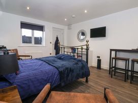 A bedroom with a bed and TV at Chalet 5 in Sherburn