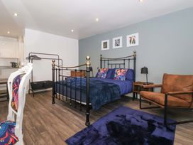 A bedroom with a bed and chair at Chalet 5 in Sherburn