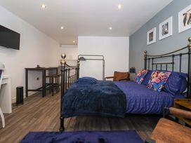 A bedroom with a bed, table, and chairs at Chalet 5 in Sherburn