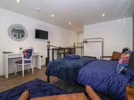 A bedroom with a bed and desk at Chalet 5 in Sherburn