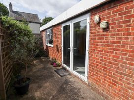 An outdoor area with brick walls and double doors at Angel's Retreat in Huttoft
