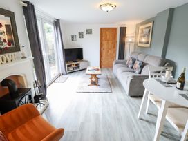 A living room with a sofa and television at Angel's Retreat in Huttoft