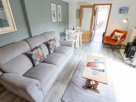A living room with a sofa, chairs, and table at Angel's Retreat in Huttoft