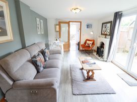 A living room with a sofa, coffee table, and fireplace at Angel's Retreat in Huttoft
