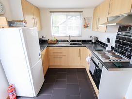 A kitchen with a refrigerator, sink, and stove at Angel's Retreat in Huttoft