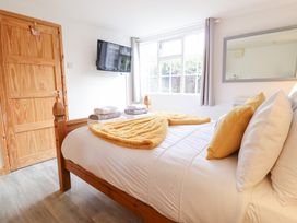 A bedroom with a bed and television at Angel's Retreat in Huttoft