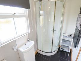 A bathroom with a shower and sink at Angel's Retreat in Huttoft