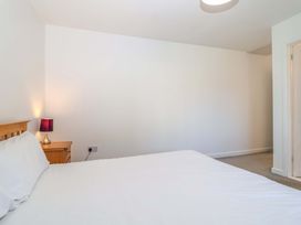 A bedroom with a bed and bedside table at Bracken Cottage St Tudy