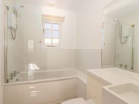 A bathroom with a bathtub and sink at Bracken Cottage St Tudy
