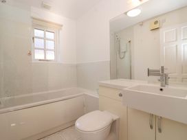A bathroom with a bath tub and sink at Bracken Cottage St Tudy