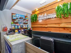 A reception area with a desk and wall display at Bracken Cottage St Tudy