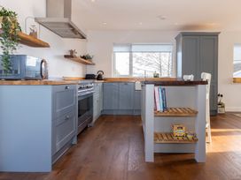 A kitchen with cabinets and an island at 38 Venn Park in Stoke Fleming