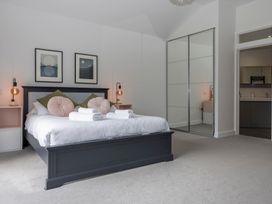 A bedroom with a bed and bedside tables at 38 Venn Park Stoke Fleming
