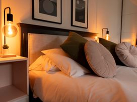 A bedroom with a bed and decorative pillows at 38 Venn Park Stoke Fleming