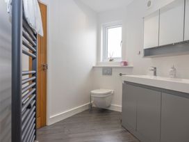 A bathroom with a sink, toilet, and radiator at 38 Venn Park in Stoke Fleming