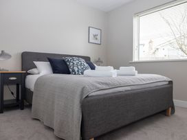 A bedroom with a bed and bedside table at 38 Venn Park Stoke Fleming