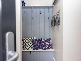 A mudroom with a bench and pillows at 38 Venn Park in Stoke Fleming