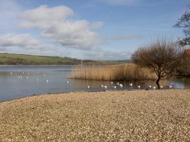 A natural landscape with a lake and birds at 38 Venn Park Stoke Fleming