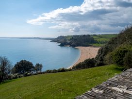 A beach with a view of hills and clouds at 38 Venn Park Stoke Fleming