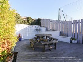 A garden with a wooden table and benches at Pond Farm View in Hinderwell