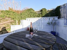 An outdoor area with a table, champagne bottle, and glasses at Pond Farm View in Hinderwell