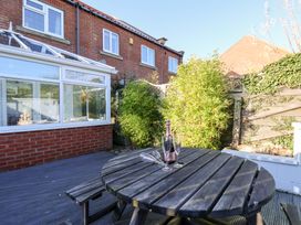 A garden with a wooden table and bamboo at Pond Farm View in Hinderwell
