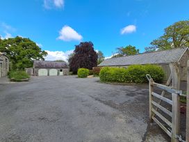 An outdoor space with buildings and trees at Dryslwyn Cottage in Llandeilo